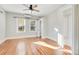 Spacious bedroom with hardwood floors, natural light, and a ceiling fan, creating a comfortable and inviting retreat at 404 W 19Th St, Sanford, FL 32771