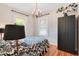 Tastefully decorated bedroom with hardwood floors, a chandelier, and a dark wardrobe for ample storage at 404 W 19Th St, Sanford, FL 32771