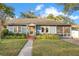 Charming single-story home with a well-manicured lawn and inviting yellow front door at 404 W 19Th St, Sanford, FL 32771