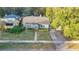 A charming home with a lush lawn and a classic yellow door, complemented by mature landscaping for curb appeal at 404 W 19Th St, Sanford, FL 32771