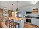 Spacious kitchen with stainless steel appliances, butcher block island with seating, and stylish shelving at 404 W 19Th St, Sanford, FL 32771