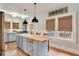 Bright kitchen boasts a large island with seating, natural lighting, and rustic decor, creating a cozy atmosphere at 404 W 19Th St, Sanford, FL 32771