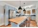Modern kitchen showcasing stainless steel appliances, blue cabinets, and large butcher block island with seating at 404 W 19Th St, Sanford, FL 32771