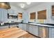 Charming kitchen features stainless steel appliances, blue cabinets, butcher block island and subway tile backsplash at 404 W 19Th St, Sanford, FL 32771