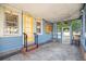 Inviting screened-in porch with brick steps, string lights, and yellow door detail creates a cozy outdoor space at 404 W 19Th St, Sanford, FL 32771