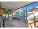 Relaxing screened-in porch with brick accents, natural light, and open space ideal for outdoor living at 404 W 19Th St, Sanford, FL 32771