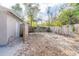 Side yard featuring a partial fence and sand and leaf ground covering at 424 S Observatory Dr, Orlando, FL 32835