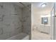 Bright bathroom featuring a tub with marble tiling and a modern vanity with sink at 424 S Observatory Dr, Orlando, FL 32835