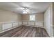 Bedroom with laminate flooring, a ceiling fan, and accent wall wainscotting at 424 S Observatory Dr, Orlando, FL 32835