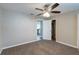 Bedroom with a ceiling fan and doorway to the kitchen in neutral, pleasing colors at 424 S Observatory Dr, Orlando, FL 32835