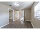 Bedroom with laminate flooring, a window for natural light, and open closet space at 424 S Observatory Dr, Orlando, FL 32835