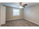 Comfortable bedroom featuring ceiling fan, carpet flooring, and a view of backyard at 424 S Observatory Dr, Orlando, FL 32835