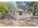 Rear exterior view of the home showing siding, windows, and partial driveway at 424 S Observatory Dr, Orlando, FL 32835
