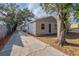 Charming home with a long driveway leading to a detached garage and tidy landscaping at 424 S Observatory Dr, Orlando, FL 32835