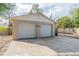 Two-car detached garage with painted doors and concrete apron at 424 S Observatory Dr, Orlando, FL 32835