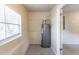 Utility room with a window, a water heater, and access to another room at 424 S Observatory Dr, Orlando, FL 32835