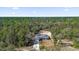 Aerial view of home featuring asphalt shingle roof nestled in wooded area at 4356 Sw Dahlia Ct, Dunnellon, FL 34431