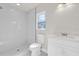 Modern bathroom with white tile shower, vanity and toilet at 4356 Sw Dahlia Ct, Dunnellon, FL 34431