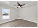 Inviting bedroom with wood flooring, ceiling fan, and ample natural light at 4356 Sw Dahlia Ct, Dunnellon, FL 34431