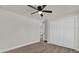 Neutral bedroom featuring ceiling fan, wood flooring, and ample closet space at 4356 Sw Dahlia Ct, Dunnellon, FL 34431