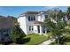 Two-story house nestled in a neighborhood, showcasing landscaping at 4636 Southlawn Ave, Orlando, FL 32811