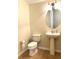 Powder room with pedestal sink and oval mirror at 4636 Southlawn Ave, Orlando, FL 32811