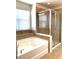 Primary bathroom with soaking tub and walk-in shower at 4636 Southlawn Ave, Orlando, FL 32811