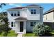 Two-story house with white exterior, brown roof, and landscaped lawn at 4636 Southlawn Ave, Orlando, FL 32811