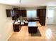 Island kitchen with granite countertops and dark wood cabinets at 4636 Southlawn Ave, Orlando, FL 32811
