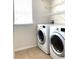 Laundry room with washer, dryer, and shelving at 4636 Southlawn Ave, Orlando, FL 32811