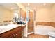 Bathroom featuring a walk-in shower, soaking tub, and granite counter at 5405 Napoli Cv, Lake Mary, FL 32746