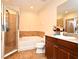 Bathroom featuring a walk-in shower, soaking tub, and granite counter at 5405 Napoli Cv, Lake Mary, FL 32746