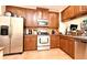 A well-equipped kitchen featuring stainless steel appliances, tile flooring and wooden cabinetry at 5405 Napoli Cv, Lake Mary, FL 32746