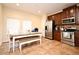 An eat-in kitchen featuring tile flooring, stainless steel appliances, wood cabinetry and dining table at 5405 Napoli Cv, Lake Mary, FL 32746