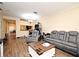 Comfortable living room with wood floors, gray sofa, chair, and white trim at 5405 Napoli Cv, Lake Mary, FL 32746