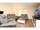 Cozy living room featuring modern gray couches, wooden floors and a media center at 5405 Napoli Cv, Lake Mary, FL 32746