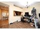 A cozy living room with hardwood flooring, a view into the kitchen and a work space at 5405 Napoli Cv, Lake Mary, FL 32746