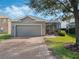 House exterior with gray garage door and brick driveway at 6361 New Independence Pkwy, Winter Garden, FL 34787