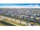 Expansive aerial view showcasing a well-planned community with modern homes under a bright blue sky at 651 Tortugas St, Haines City, FL 33844