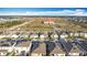 Expansive aerial view of a suburban neighborhood featuring numerous single-Gathering homes and community areas at 651 Tortugas St, Haines City, FL 33844