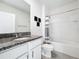 Charming bathroom with granite countertop, white vanity, shower/tub combination, and neutral finishes at 651 Tortugas St, Haines City, FL 33844