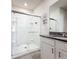 Modern bathroom with glass-enclosed shower, granite countertop, and white vanity at 651 Tortugas St, Haines City, FL 33844