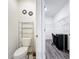Powder room features a toilet with shelving and a view into the walk-in closet/office space at 651 Tortugas St, Haines City, FL 33844