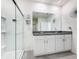 Bright bathroom features granite countertop, white cabinets, and a glass-enclosed shower at 651 Tortugas St, Haines City, FL 33844