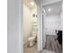 Powder room features a toilet with shelving and a view into the walk-in closet/office space at 651 Tortugas St, Haines City, FL 33844