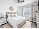 Bright bedroom featuring neutral decor, modern accents, and light colored wood flooring at 651 Tortugas St, Haines City, FL 33844