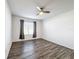 Spacious bedroom with modern ceiling fan, natural light from window, and attractive wood-look floors at 651 Tortugas St, Haines City, FL 33844