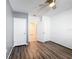 Bedroom with ceiling fan, wood-look floors, and access to hallways and closets at 651 Tortugas St, Haines City, FL 33844