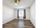 Inviting bedroom with ceiling fan, natural light from window, and stylish wood-look flooring at 651 Tortugas St, Haines City, FL 33844