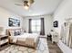 Bright bedroom with a writing desk, decorative art, and light colored wood flooring at 651 Tortugas St, Haines City, FL 33844
